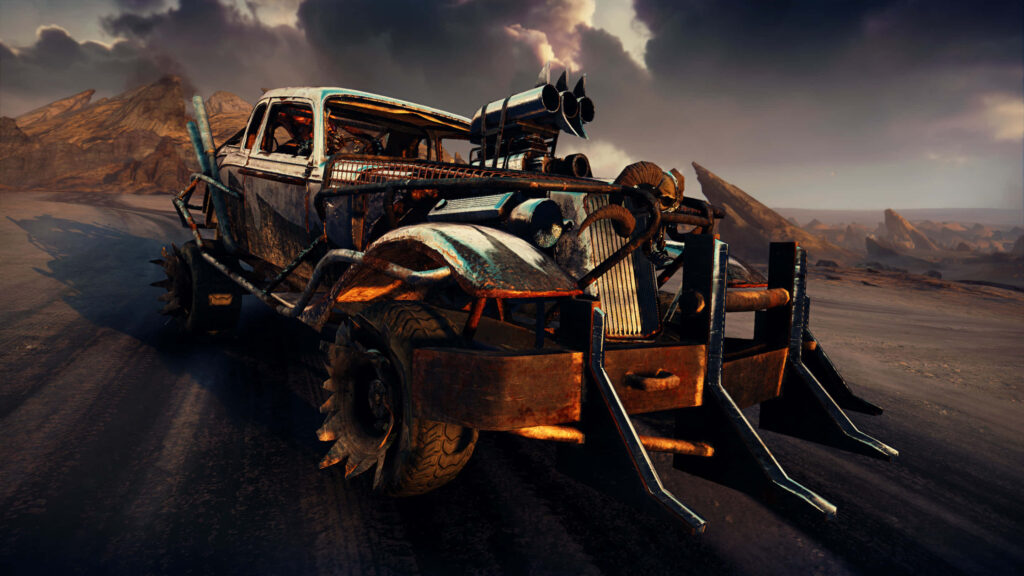 Heavy armored Mad Max vehicle speeds across desolate post-apocalyptic landscape wallpaper background