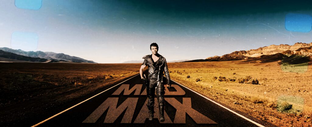 Lone figure in rugged leather on endless desert highway with Mad Max text post-apocalyptic wallpaper