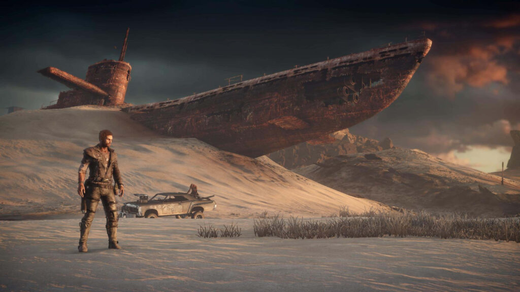 Rugged figure in barren desert with rusted shipwreck and modified car Mad Max wallpaper background