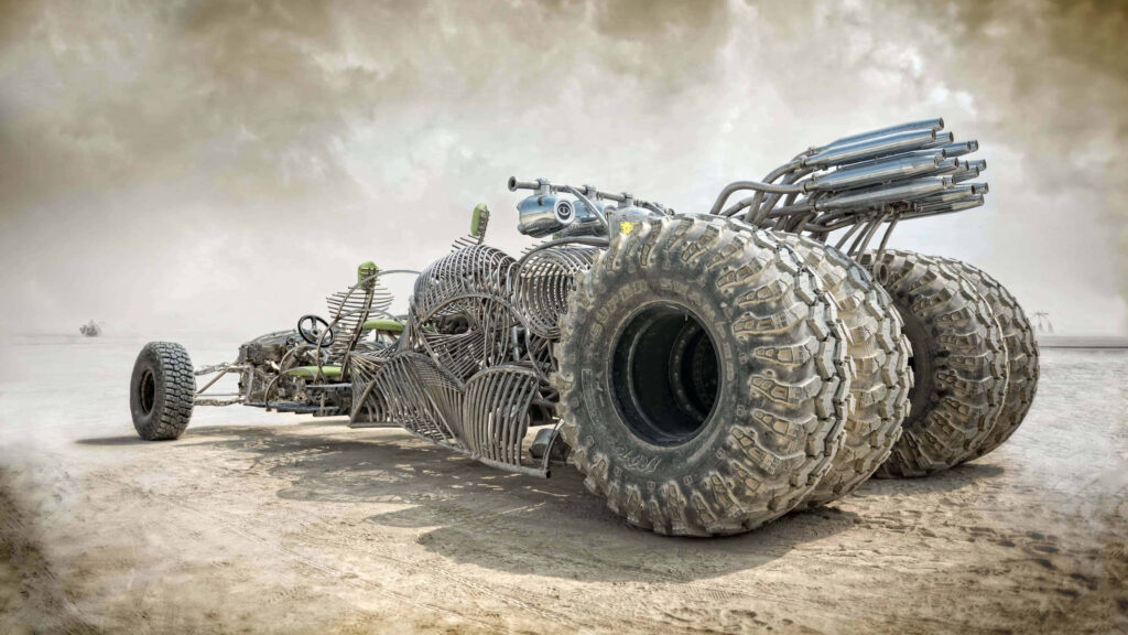 Mad Max Fury Road rugged post apocalyptic vehicle with oversized tires in desert wallpaper background