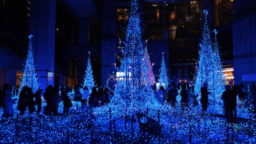Magical Urban Winter Wonderland: Blue LED Christmas Tree Display Wallpaper