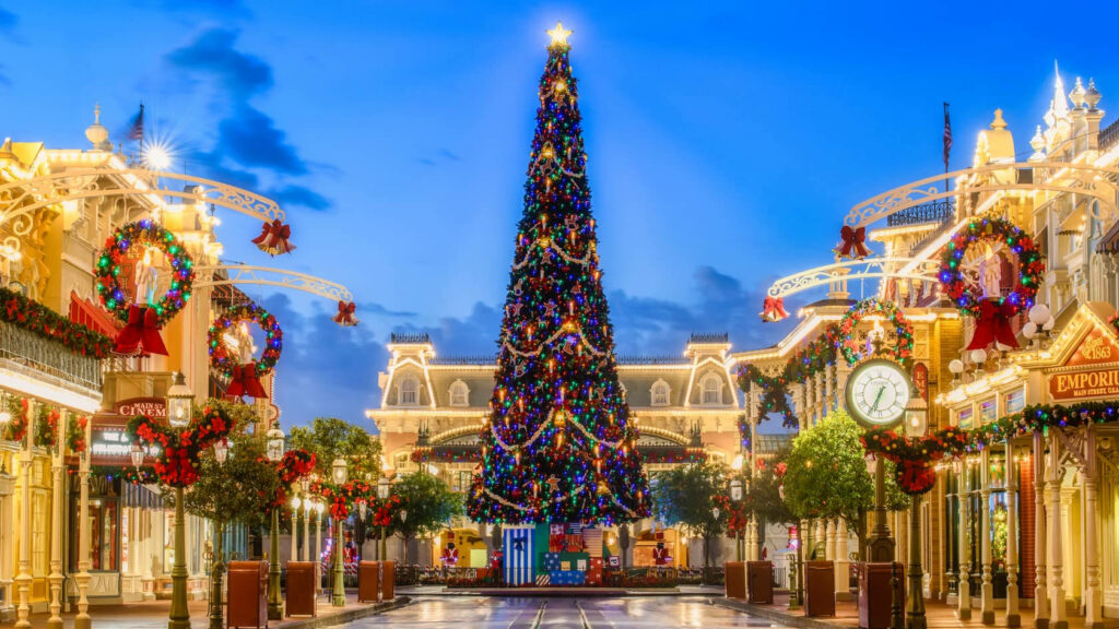 Magical Christmas Tree in Festive Street Decorated with Lights Wallpaper