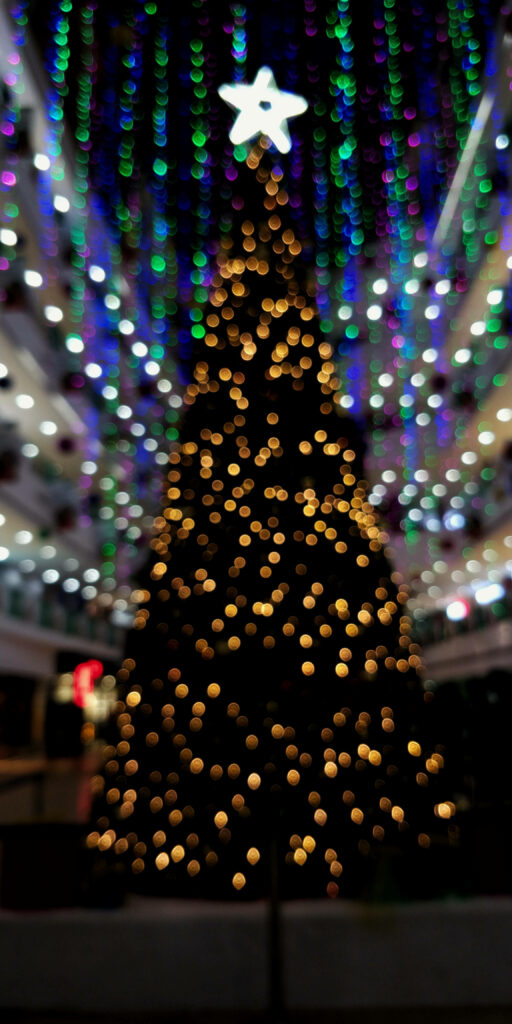 Magical Christmas Tree Wallpaper with Colorful Lights Background