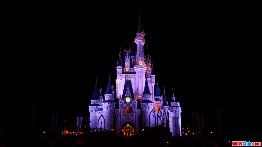 Cinderella Castle at Disney World Magic Kingdom glowing purple and gold at night wallpaper background