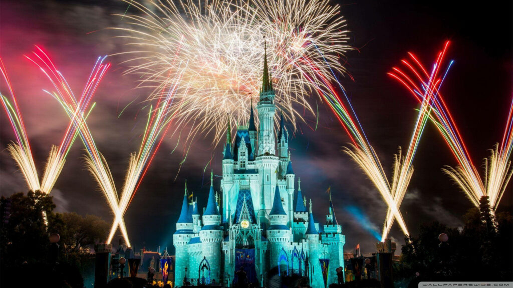 Vibrant fireworks illuminate Disney Castle at night creating a magical festive celebration scene Wallpaper