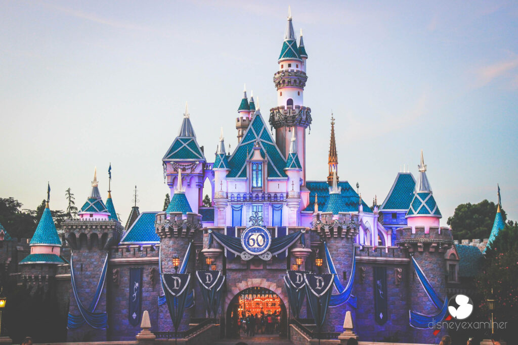 Disney Castle glowing at twilight magical night scene iconic fairytale landmark wallpaper background