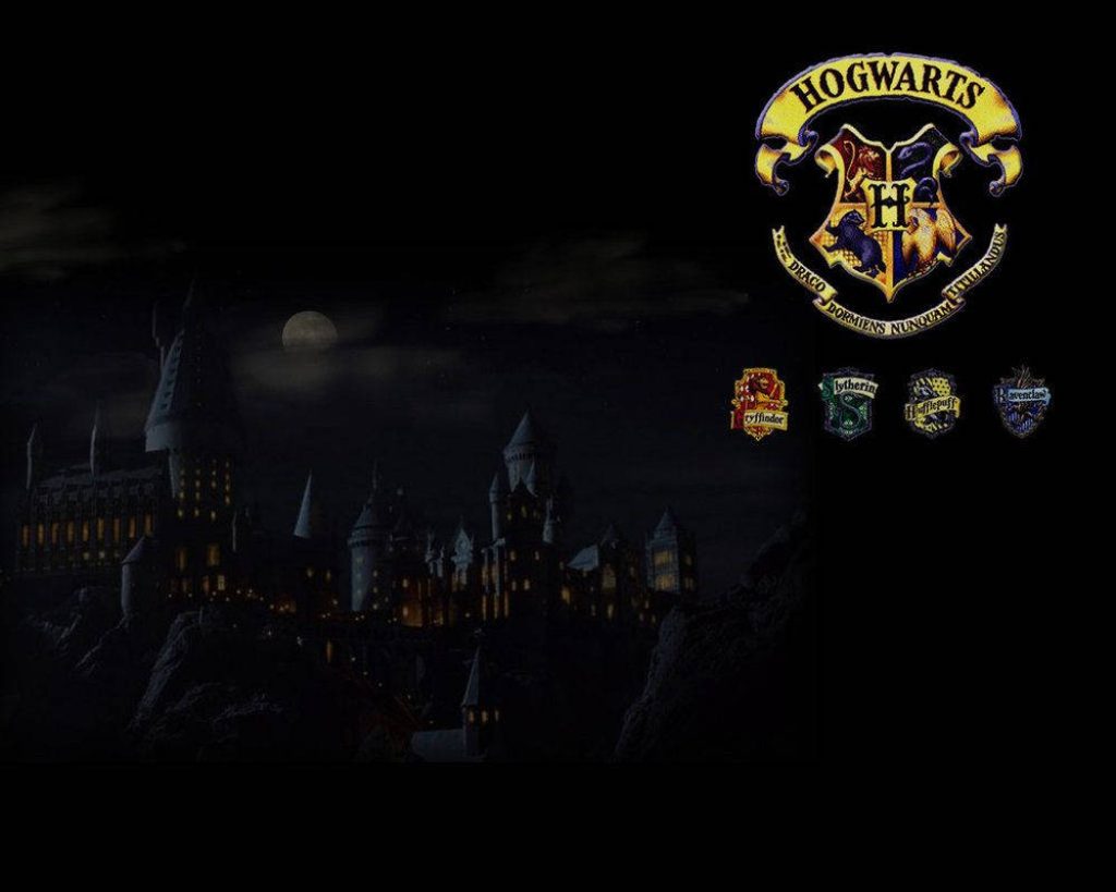 Hogwarts castle at night with moonlit sky and house crests Gryffindor Slytherin Hufflepuff Ravenclaw wallpaper