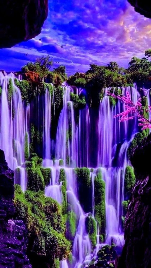 Multi-tiered waterfall cascades over mossy cliffs in a purple blue fantasy nature landscape wallpaper