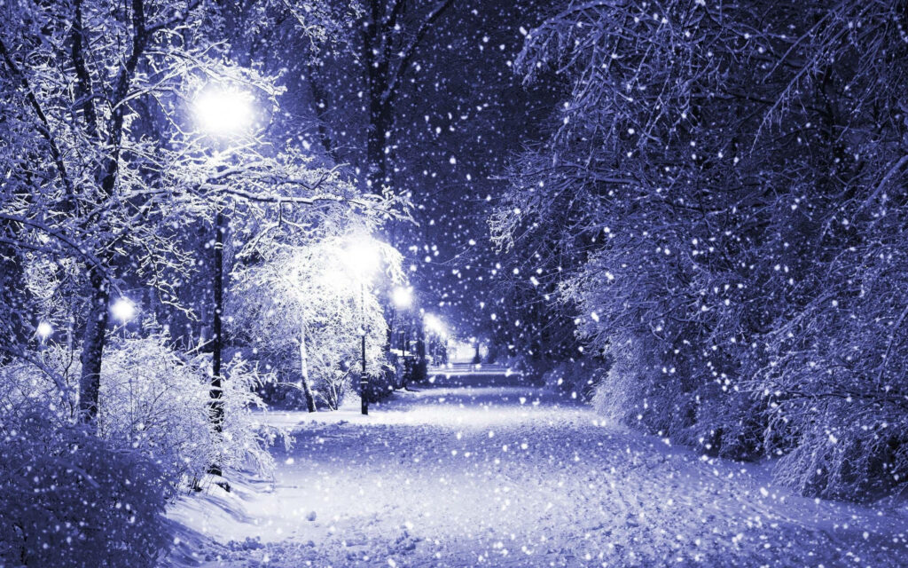 Serene Snowy Pathway: Cozy Winter Scene with Glowing Streetlights Wallpaper