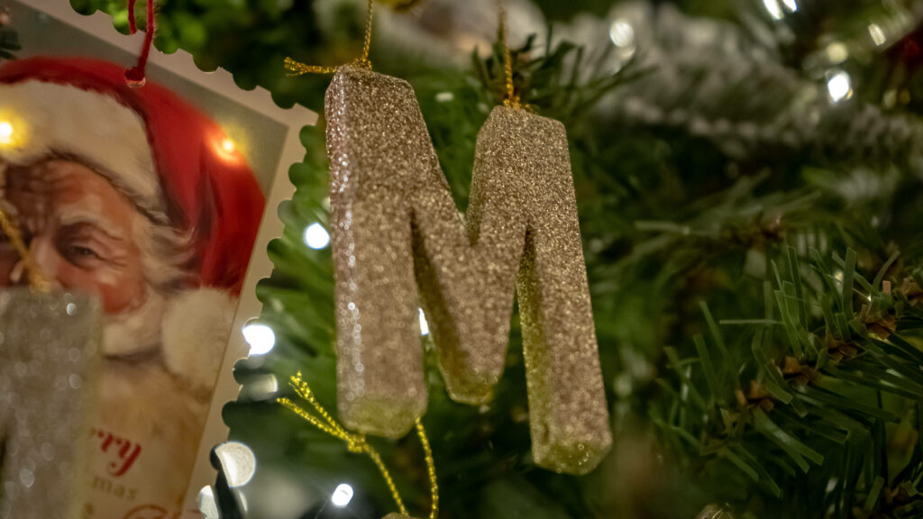 Magnificent M: Glittery Gold Christmas Decoration for Your Tree Wallpaper