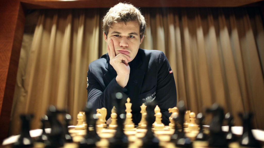 Magnus Carlsen Wallpaper: Focused Chess Champion in Strategic Setting