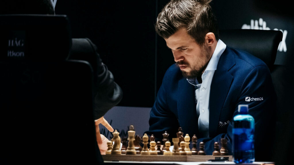 Magnus Carlsen Deep in Thought: Intense Chess Match Wallpaper
