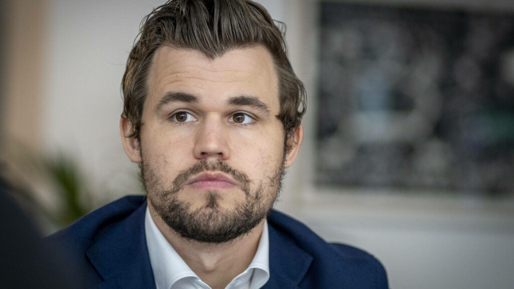 Magnus Carlsen Portrait: Thoughtful Champion with Elegant Beard Wallpaper