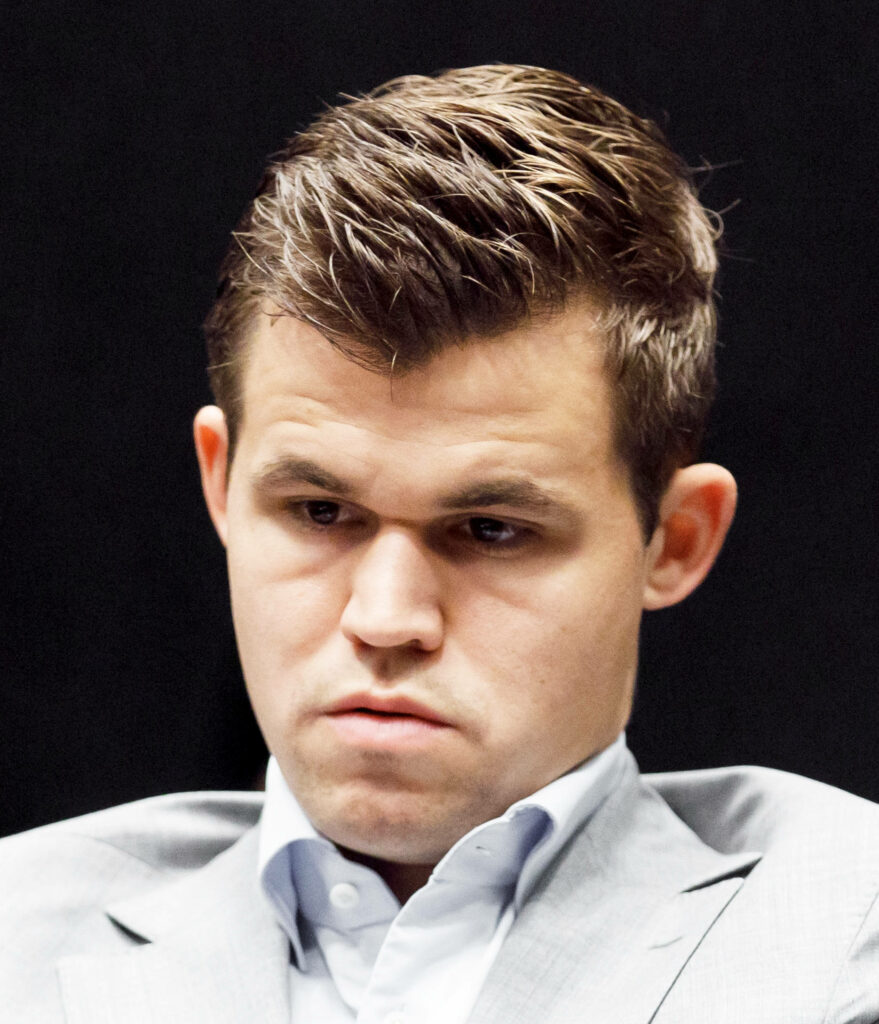 Magnus Carlsen: Focused Chess Champion Wallpaper Background