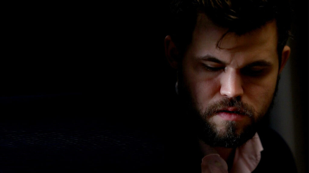 Intense Portrait of Magnus Carlsen - Chess Legend Wallpaper Background
