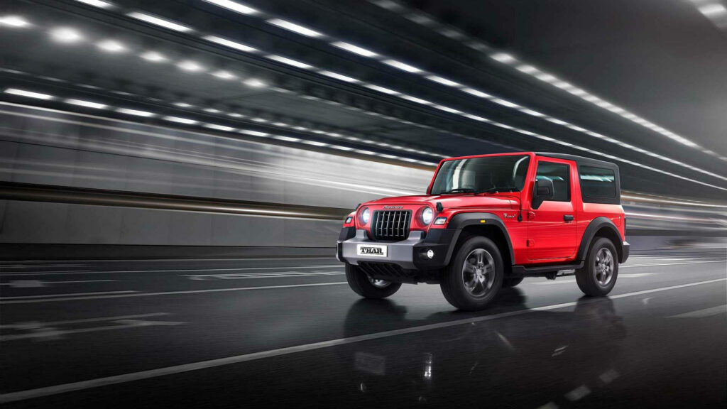 Mahindra Thar 2021 in motion urban backdrop bold design adventurous offroad SUV wallpaper