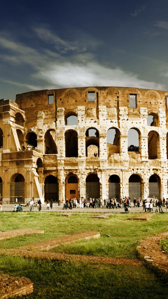 Ancient Colosseum in Rome with iconic arches textured stonework under dramatic sky wallpaper