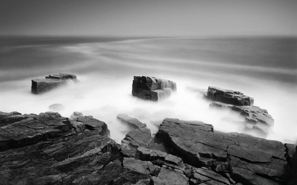 Majestic Black and White Ocean Wallpaper: Dramatic Rugged Rocks