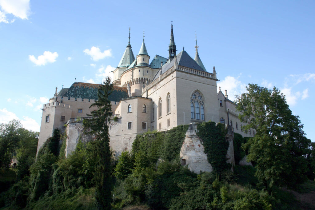 Bojnice Castle Slovakia medieval architecture towering spires stonework greenery blue sky wallpaper