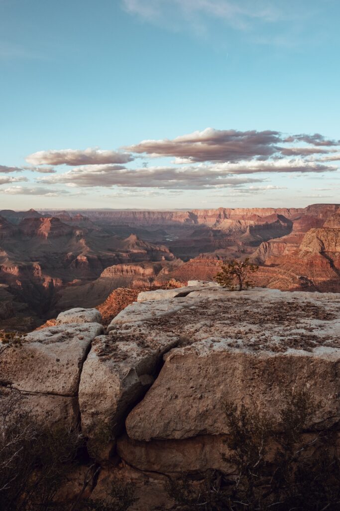 Breathtaking canyon landscape with rugged rocks under bright sky and warm sunlight highlighting textures Wallpaper