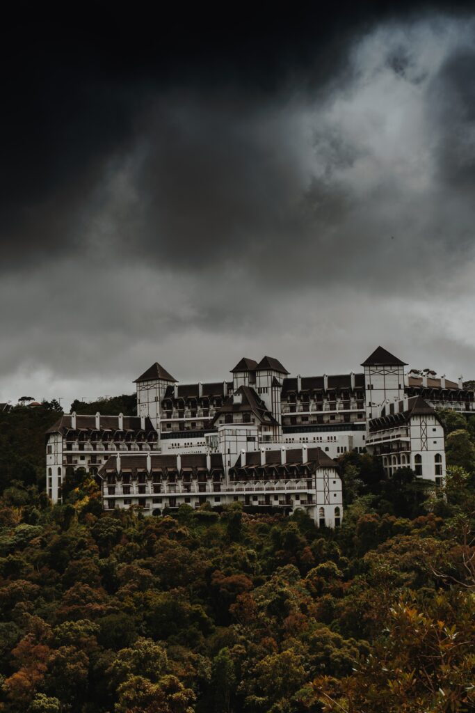 Majestic Castle Wallpaper: Lush Greenery & Dramatic Overcast Sky