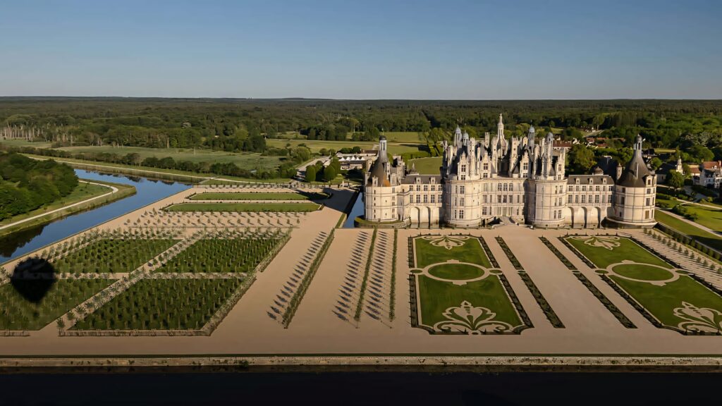Aerial view of Château de Chambord with French Renaissance architecture and symmetrical gardens Wallpaper