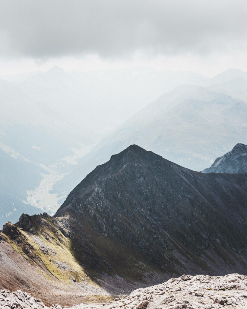 Majestic Cloud-Covered Peaks: Stunning Swiss Landscape for Captivating iOS Display Wallpaper