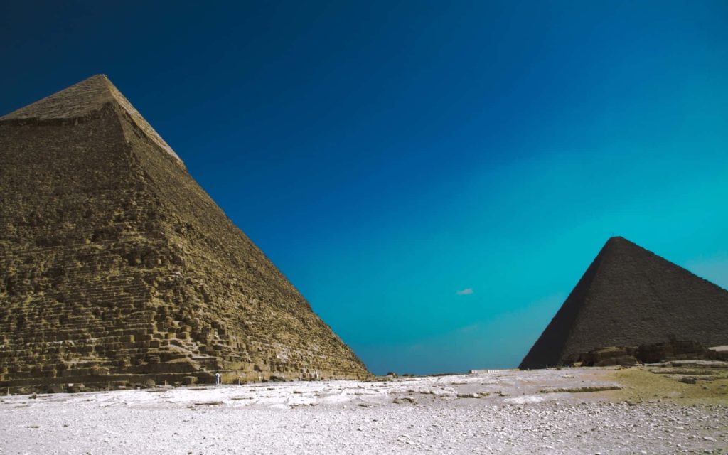 Giza Pyramids wallpaper with Great Pyramid and Pyramid of Khafre under clear blue sky