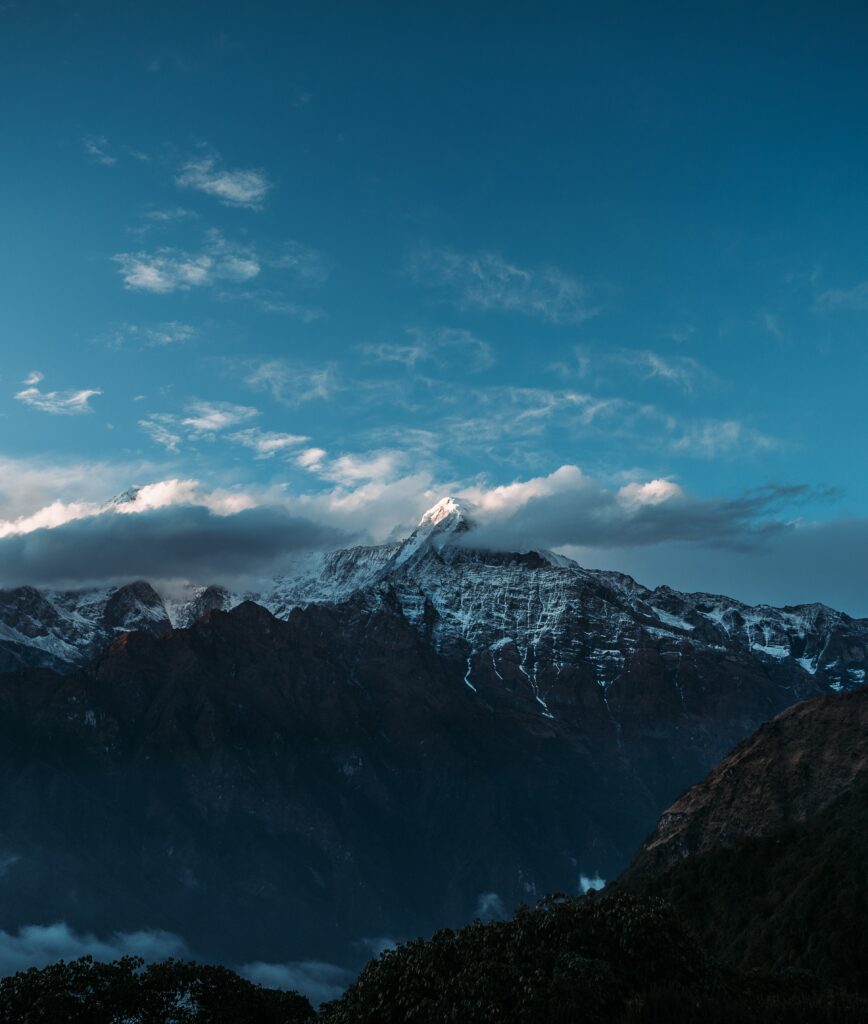 Majestic Himalayas peaks with early sunlight and clouds under a serene blue sky high resolution wallpaper