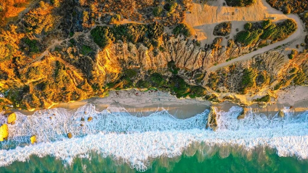 Serene Malibu Beach: A Breathtaking Aerial Capture Uniting Nature's Beauty Wallpaper