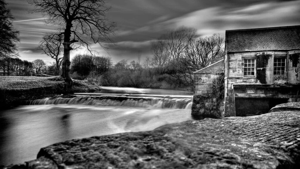 Serene Monochrome Landscape: Riverside Beauty & Historic Charm Wallpaper