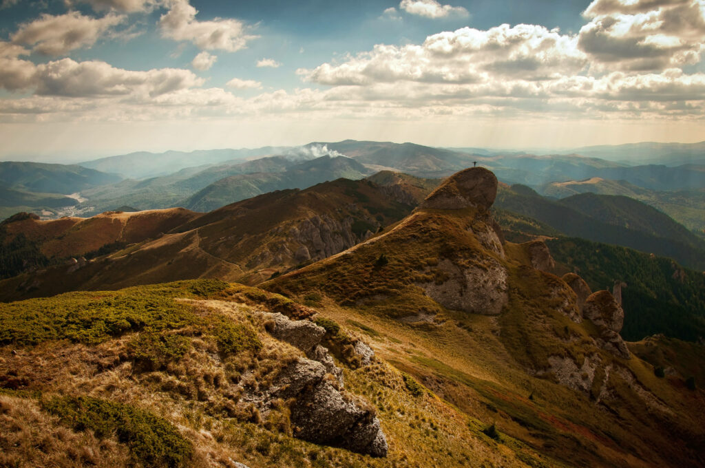 Majestic Mountain Range Amidst a Dreamy Cloudscape Wallpaper