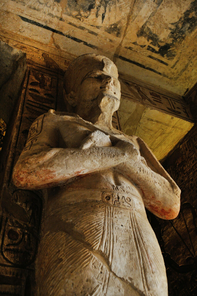 Majestic Ramses II statue wallpaper showcasing ancient Egyptian stone craftsmanship and hieroglyphics
