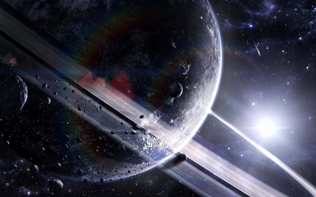Majestic ringed planet with glowing star and dense asteroid field in dark cosmic space wallpaper