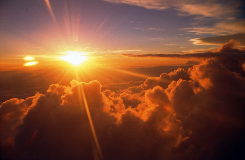 Aerial view of golden sunset clouds with warm orange and purple hues vibrant sky wallpaper