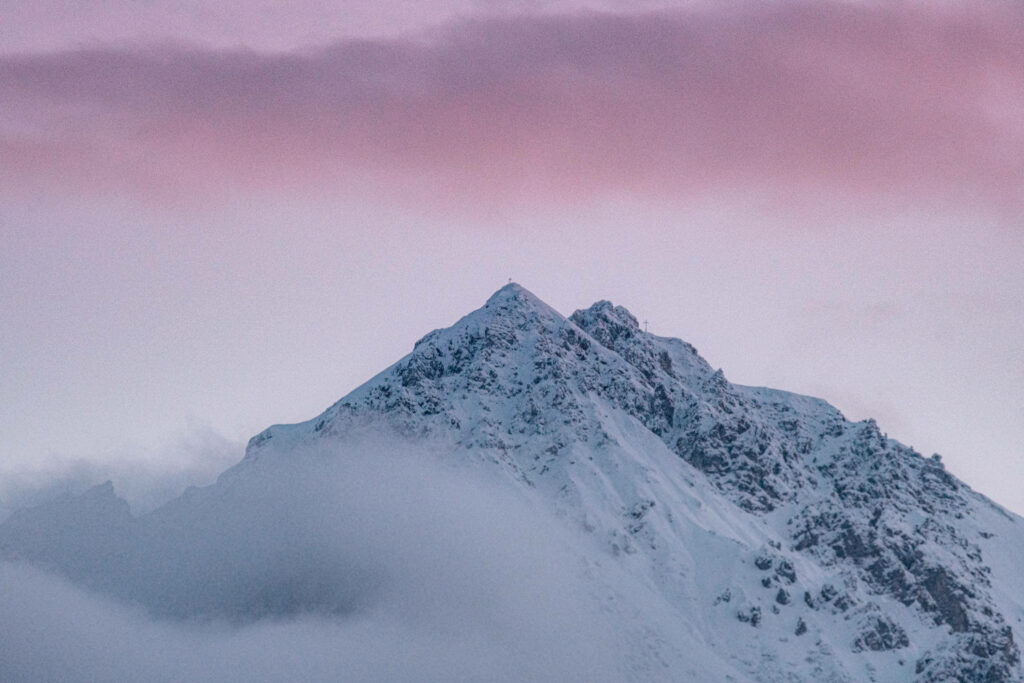 Twilight Majesty: An Enchanting Snow-Covered Mountain Peak on Winter Desktop Wallpaper
