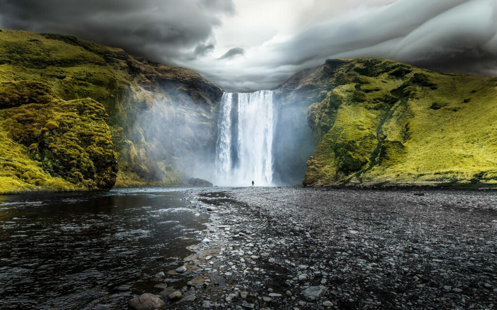 Majestic Waterfall Wallpaper: Serene Nature Under Overcast Sky