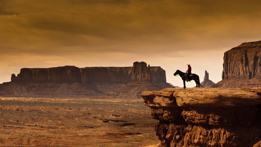 Stunning Wild West Wallpaper: Lone Rider Over Desert Canyons