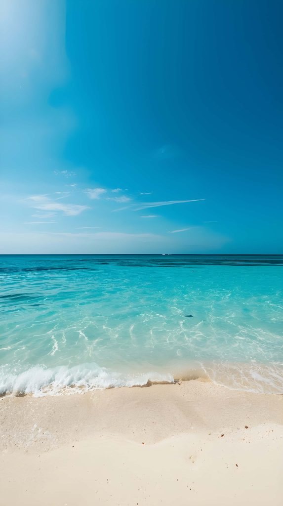 Maldives tropical beach with turquoise waters white sand and clear blue sky wallpaper background