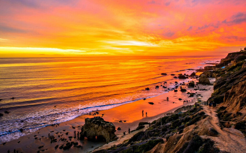 Orange Hues of Panoramic Malibu Beach Sunset Captured from Above Wallpaper