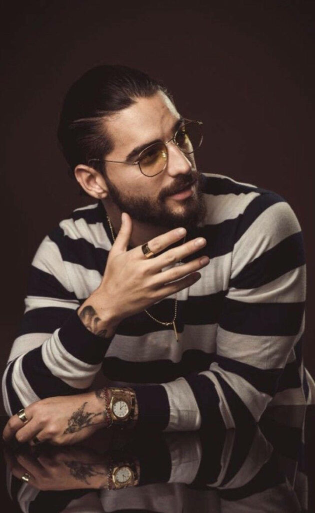 Maluma stylish portrait wearing striped shirt rings watch and glasses iconic rapper singer look wallpaper