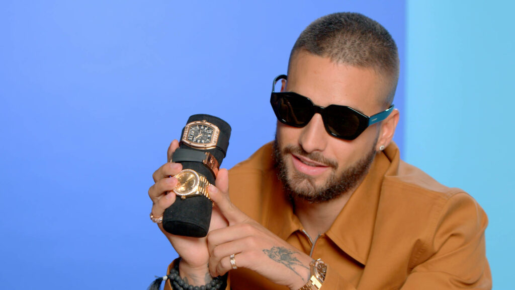 Maluma displaying luxury watch collection stylishly blending fashion and music artist flair wallpaper