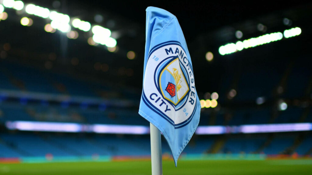 Manchester City flag waves at stadium corner vibrant home ground atmosphere wallpaper background