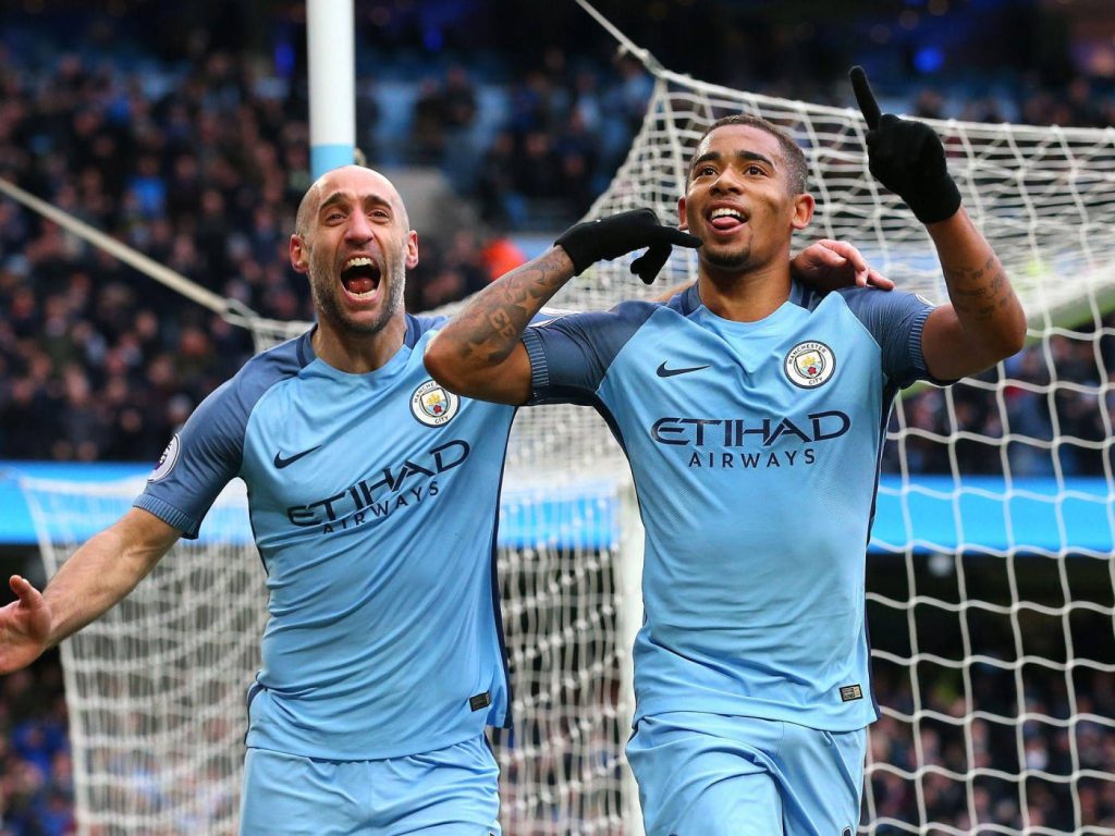 Manchester City stars Gabriel Jesus and Pablo Zabaleta celebrate goal in stadium wallpaper