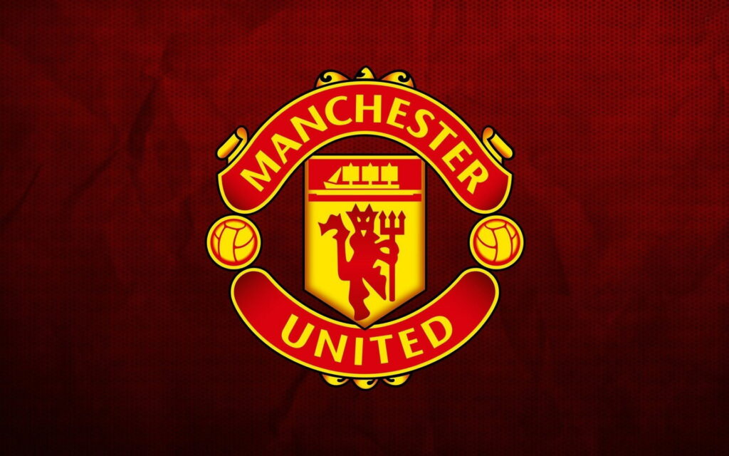 Red Devils Unleashed: The Mighty Manchester United Emblem in HD Glory Wallpaper
