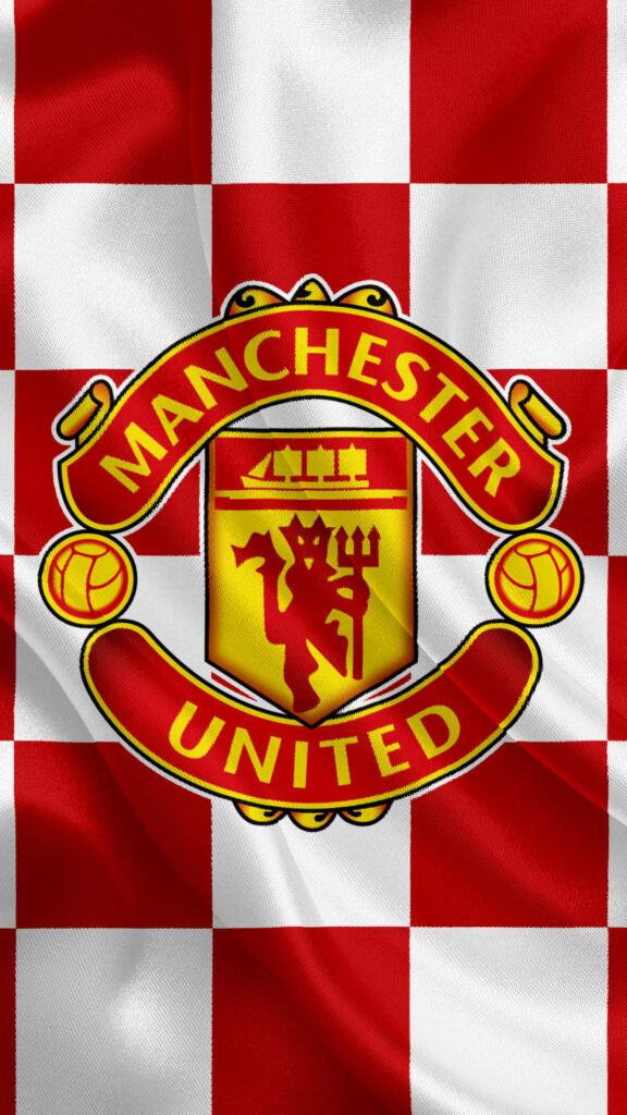 Manchester United logo on bold red and white checkered wallpaper capturing club pride