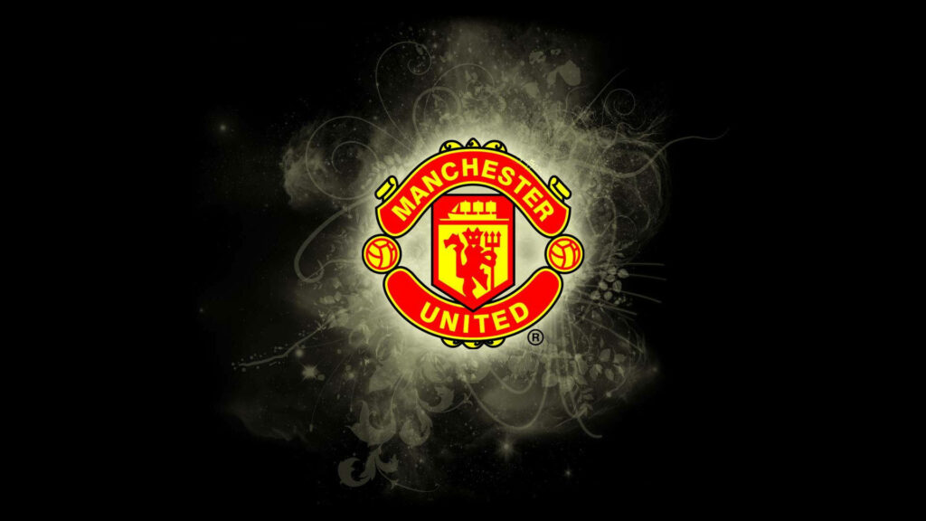 Manchester United logo with swirling grey smoke and abstract patterns on dark wallpaper background