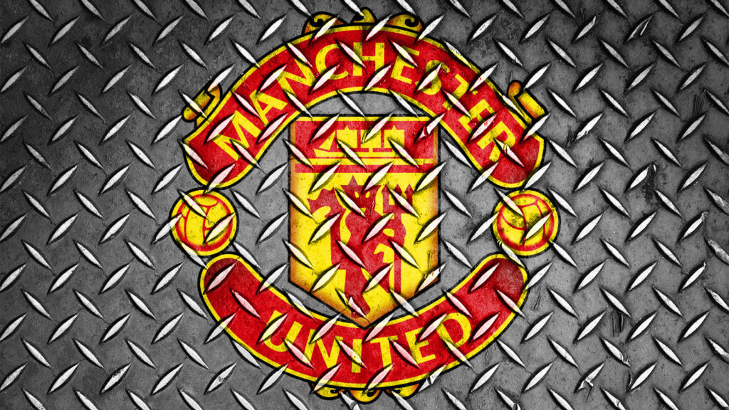 Manchester United logo on rugged industrial metal pattern background football club wallpaper