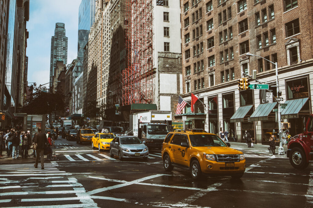 Dynamic Manhattan Street Scene with Yellow Taxis and Iconic Skylines Wallpaper