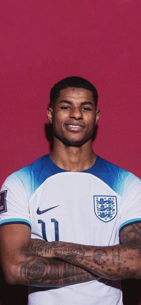 Marcus Rashford England footballer 2022 jersey studio portrait red background tattoos smile Wallpaper